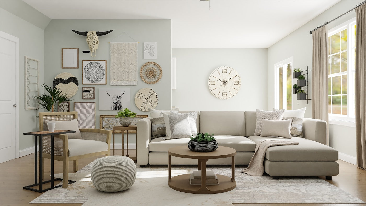 Neutral living room with layered wall decor, seating, and a round coffee table